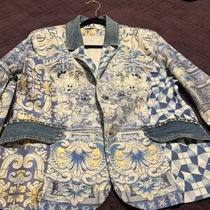 Multi-colored diamond studded jacket with denim background.